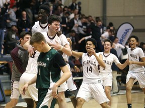 The St. Paul's Crusaders celebrate a win over the Vincent Massey Trojans in the 'AAAA' provincial high school basketball championship on Monday. (KEVIN KING/Winnipeg Sun)