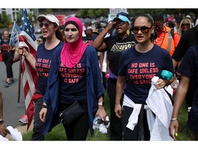 Activist Linda Sarsour (C) and fellow gun-control activists participate in a march beginning at the headquarters of National Rifle Association July 14, 2017 in Fairfax, Virginia.