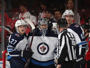 Jets goalie Connor Hellebuyck celebrates his 3-2 victory over the New Jersey Devils at the Prudential Center in Newark, New Jersey. With his 35th victory of the season Hellebuyck breaks the team season record of 34.  (Photo by Bruce Bennett/Getty Images)