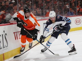 Patrik Laine of the Winnipeg Jets skates (right) against Ivan Provorov of the Philadelphia Flyers during the third period on Saturday, in Philadelphia.