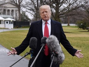 President Donald Trump answers questions from the media as he departs from the South Lawn of the White House on February 23, 2018 in Washington, DC.