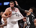 Brooklyn Nets guard D'Angelo Russell, right, grabs the jersey of Toronto Raptors center Jonas Valanciunas (17), for which he drew a foul call, Tuesday, March 13, 2018, in New York. The Raptors defeated the Nets 116-102. The Associated Press