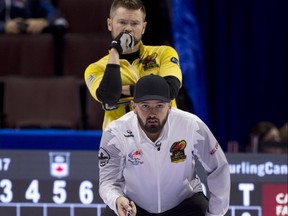 Kanata ON.December 2, 2017.Tim Hortons Roar of the Rings Curling Trials. Winnipeg Mb face off in draw 2 of the Trials.Skip Reid Carruthers, skip Mike McEwen (background) check the stones line during their cross city rival evening match. michael burns photo ORG XMIT: POS1712022004163707