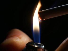 A picture taken on Sept. 29, 2017 shows a close-up shot of a man lighting a cigarette.