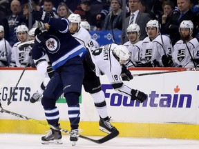 Winnipeg Jets centre Adam Lowry (17) hits Los Angeles Kings defenceman Drew Doughty (8) during second period NHL hockey action in Winnipeg, Tuesday, March 20, 2018. THE CANADIAN PRESS/Trevor Hagan ORG XMIT: WPGT111