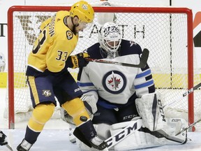 Winnipeg Jets goalie Michael Hutchinson (right) was pulled early in the evening against the Nashville Predators. (AP)