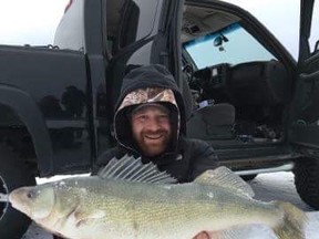 A man holds a large walleye caught while ice fishing on Lake Winnipeg last week. Supplied photo.