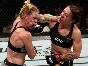 Cris 'Cyborg' Justino punches Holly Holm in their women's featherweight bout during UFC 219 in T-Mobile Arena on December 30, 2017 in Las Vegas. (Jeff Bottari/Zuffa LLC/Zuffa LLC via Getty Images)