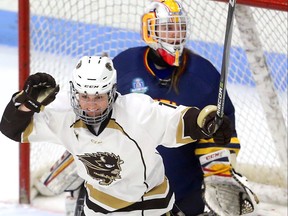 Courtlyn Oswald of the Manitoba Bisons celebrates her first period goal in front of Queens Gaels goaltender Stephanie Pascal in their USports women's hockey quarterfinal game Friday March 16, 2018.  Mike Hensen/The London Free Press/Postmedia Network