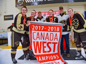 (left to right) Alana Serhan (14), Erica Reider, Caitlin Fyten and Alanna Sharman (24) of the University of Manitoba Bisons women's hockey team celebrate after beating the Saskatchewan Huskies 5-2 in Game 2 and sweep the best-of-three Canada West women's hockey final, Saturday, March 3, 2018 at the Wayne Fleming Arena in Winnipeg. The Bisons advance to the USports championship, March 15-18 in London, Ont.