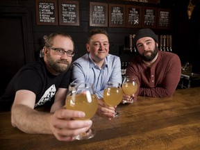 Barn Hammer Brewing Company Head Brewer Brian Westcott, left to right, University of Winnipeg Associate Professor and Chair of Classics Dr. Matt Gibbs, and Barn Hammer Brewing Company Owner Tyler Birch pose for a photo after they teamed up to recreate an ancient beer the old-fashioned way at Barn Hammer Brewing Company in Winnipeg on Tuesday March 13, 2018.