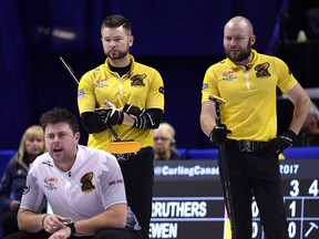 Team McEwen skip Mike McEwen and third B.J. Neufeld watch a shot as Team Carruthers third Braeden Moskowy calls to his sweepers at the 2017 Roar of the Rings Canadian Olympic Curling Trials in Ottawa on Saturday, Dec. 2, 2017. The team is parting ways after 11 years together. THE CANADIAN PRESS/Justin Tang ORG XMIT: JDT131