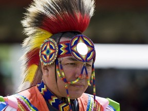 Dennis Meeches of Long Plain First Nation walks towards the arena for the grand entry during the Long Plain's pow wow on Aug. 3. More than 300 dancers from across North America came to compete at the event. (Svjetlana Mlinarevic/Portage Daily Graphic/QMI Agency)