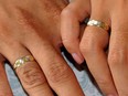 Photo taken October 10, 2010 shows a couple holding hands during a mass wedding of 250 couples in Manila. Qualified support for divorce is rising in the mainly Roman Catholic Philippines, the world's remaining holdout apart from the Vatican, according to an independent nationwide survey released on June 2, 2011.    AFP PHOTO / JAY DIRECTO