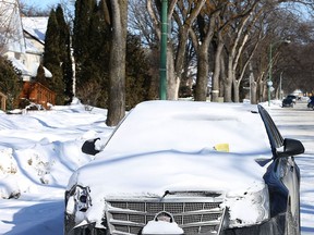 A vehicle with a ticket for violating the annual snow route parking ban sits on Fleet Avenue in Winnipeg, Man., on Sun., Feb. 22, 2015. Kevin King/Winnipeg Sun/QMI Agency