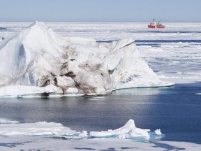 A iceberg floating in the Baffin Bay above the arctic circle dwarfs the Canadian Coast Guard icebreaker Louis S. St-Laurent THE CANADIAN PRESS/Jonathan Hayward ORG XMIT: CPT129