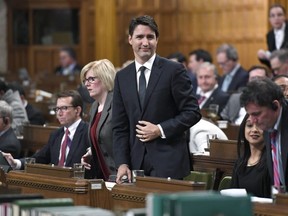 Prime Minister Justin Trudeau rises to vote during a marathon voting session in the House of Commons on Parliament Hill in Ottawa on Friday, March 23, 2018.