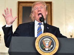 US President Donald Trump speaks about the spending bill during a press conference in the Diplomatic Reception Room at the White House on March 23, 2018. / AFP PHOTO