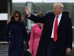 President Donald Trump and first lady Melania Trump walk from Marine One towards Air Force One at Andrews Air Force Base, Md., Monday, March 19, 2018.