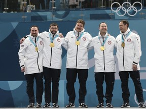 FILE - In this Feb. 24, 2018, file photo, the United States team poses with their gold medals after winning the men's final curling match against Sweden at the 2018 Winter Olympics in Gangneung, South Korea. The country’s first curling gold medal has given the steadily-growing sport another shot in the arm. (AP Photo/Natacha Pisarenko, File)
