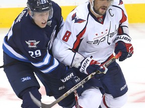 Winnipeg Jets right winger Patrik Laine (l) and Washington Capitals left winger Alex Ovechkin tangle during NHL hockey in Winnipeg, Man. Tuesday November 01, 2016. Brian Donogh/Winnipeg Sun/Postmedia Network