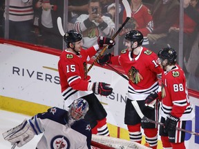 Chicago Blackhawks left wing Tomas Jurco (13) celebrates with center Artem Anisimov (15) and right wing Patrick Kane (88) after scoring against the Winnipeg Jets during the second period of an NHL hockey game Thursday, March 29, 2018, in Chicago. (AP Photo/Kamil Krzaczynski) ORG XMIT: CXA113
