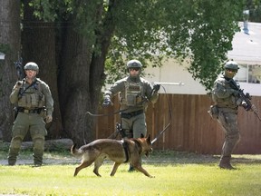RCMP officers in tactical gear search for a lone male suspect believed to be armed in the north end of Portage la Prairie on Tuesday, June 27. The Independent Investigation Unit of Manitoba cleared one of the officers of shooting the suspect during his arrest, it was anno9unced Friday.