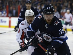 Winnipeg Jets defenceman Toby Enstrom retreats with Washington Capitals forward Alex Ovechkin in pursuit in Winnipeg on Tues., Feb. 13, 2018. Kevin King/Winnipeg Sun/Postmedia Network