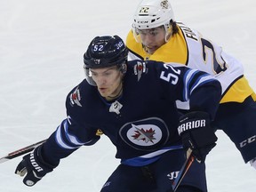 Winnipeg Jets forward Jack Roslovic (left) fends off Nashville Predators forward Kevin Fiala in Winnipeg on Tues., Feb. 27, 2018.  If Roslovic’s flu symptoms are gone, he’ll play Friday against the Ducks. Kevin King/Winnipeg Sun/Postmedia Network