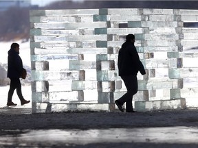 A backlit wall of stacked ice attracts passersby on the Red River, south of The Forks, Friday. The City of Winnipeg said it is actively preparing for a variety of flood scenarios including potential ice effects on river levels. Preparations include ensuring that all flood protection infrastructure is operable and activated, identifying at-risk properties and liaising with stakeholders.