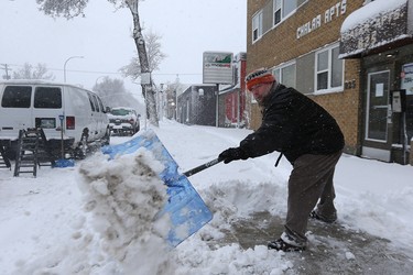 Ted St. John shovels the sidewalk in front of an apartment block he manages on Corydon Avenue in Winnipeg on Mon., March 5, 2018. Kevin King/Winnipeg Sun/Postmedia Network