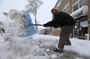 Ted St. John shovels the sidewalk in front of an apartment block he manages on Corydon Avenue in Winnipeg on Mon., March 5, 2018. Kevin King/Winnipeg Sun/Postmedia Network