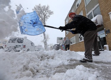 Ted St. John shovels the sidewalk in front of an apartment block he manages on Corydon Avenue in Winnipeg on Mon., March 5, 2018. Kevin King/Winnipeg Sun/Postmedia Network
