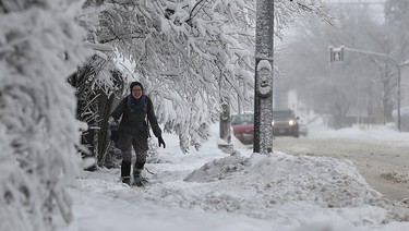 Rachael Kroeker negotiates her way around low-hanging branches as she snowshoes along Stafford Street in Winnipeg on Mon., March 5, 2018. Kevin King/Winnipeg Sun/Postmedia Network