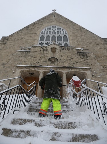 Snow is cleared from the steps of St. Ignatius Church on Stafford Street in Winnipeg on Mon., March 5, 2018. Kevin King/Winnipeg Sun/Postmedia Network