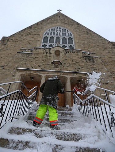 Snow is cleared from the steps of St. Ignatius Church on Stafford Street in Winnipeg on Mon., March 5, 2018. Kevin King/Winnipeg Sun/Postmedia Network
