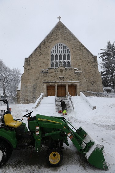 Snow is cleared from the steps of St. Ignatius Church on Stafford Street in Winnipeg on Mon., March 5, 2018. Kevin King/Winnipeg Sun/Postmedia Network