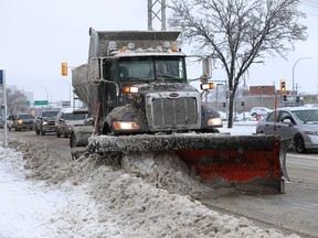 A plow works south on Pembina Highway on Monday.