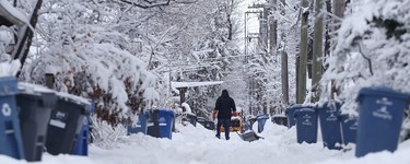 A man shovels in a backlane in the Crescentwood area of Winnipeg on Mon., March 5, 2018. Kevin King/Winnipeg Sun/Postmedia Network