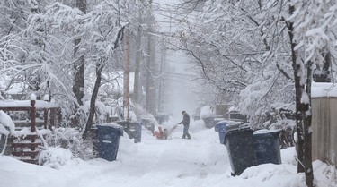 A man plows in a backlane in the Crescentwood area of Winnipeg on Mon., March 5, 2018. Kevin King/Winnipeg Sun/Postmedia Network