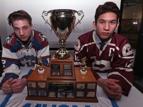Captains Mack Whitely (left) of the Sturgeon Heights Huskies and Michael Lee of the St. Paul's Crusaders pose with the Don Barton Cup during a press conference at the Manitoba Sports Hall of Fame in Winnipeg on Tues., March 6, 2018. The trophy will go to the winner of the 'AAAA' provincial high school hockey championships taking place this weekend at Bell MTS Iceplex. Kevin King/Winnipeg Sun/Postmedia Network