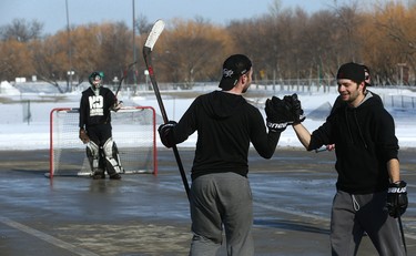 Participants celebrate a goal during the Fivehole for Five Days street hockey tournament in a parking lot on the University of Manitoba's Fort Garry Campus in Winnipeg on Sun., March 11, 2018. The event is one of a number taking place in support of the 5 Days for the Homeless campaign, which is raising funds for Resource Assistance for Youth. Kevin King/Winnipeg Sun/Postmedia Network