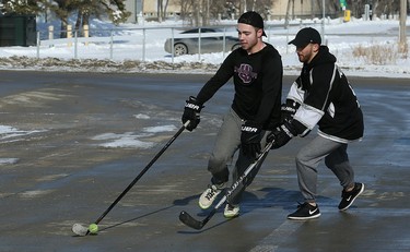 It's game on at the Fivehole for Five Days street hockey tournament in a parking lot on the University of Manitoba's Fort Garry Campus in Winnipeg on Sun., March 11, 2018. The event is one of a number taking place in support of the 5 Days for the Homeless campaign, which is raising funds for Resource Assistance for Youth. Kevin King/Winnipeg Sun/Postmedia Network