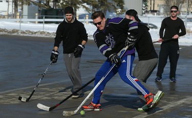 It's game on at the Fivehole for Five Days street hockey tournament in a parking lot on the University of Manitoba's Fort Garry Campus in Winnipeg on Sun., March 11, 2018. The event is one of a number taking place in support of the 5 Days for the Homeless campaign, which is raising funds for Resource Assistance for Youth. Kevin King/Winnipeg Sun/Postmedia Network