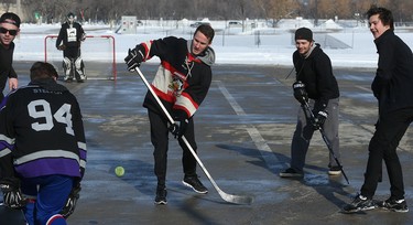 It's game on at the Fivehole for Five Days street hockey tournament in a parking lot on the University of Manitoba's Fort Garry Campus in Winnipeg on Sun., March 11, 2018. The event is one of a number taking place in support of the 5 Days for the Homeless campaign, which is raising funds for Resource Assistance for Youth. Kevin King/Winnipeg Sun/Postmedia Network