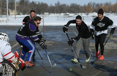 It's game on at the Fivehole for Five Days street hockey tournament in a parking lot on the University of Manitoba's Fort Garry Campus in Winnipeg on Sun., March 11, 2018. The event is one of a number taking place in support of the 5 Days for the Homeless campaign, which is raising funds for Resource Assistance for Youth. Kevin King/Winnipeg Sun/Postmedia Network