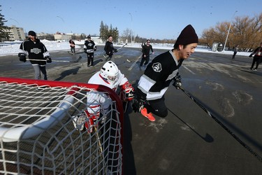 It's game on at the Fivehole for Five Days street hockey tournament in a parking lot on the University of Manitoba's Fort Garry Campus in Winnipeg on Sun., March 11, 2018. The event is one of a number taking place in support of the 5 Days for the Homeless campaign, which is raising funds for Resource Assistance for Youth. Kevin King/Winnipeg Sun/Postmedia Network