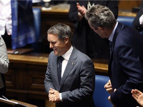 Finance Minister Cameron Friesen (centre) enjoyes the reaction of his party, including Premier Brian Pallister (right) and Sustainable Development Minister Rochelle Squires (left) to the Budget 2018 speech delivered by in the Manitoba Legislature in Winnipeg on Mon., March 12, 2018. Kevin King/Winnipeg Sun/Postmedia Network