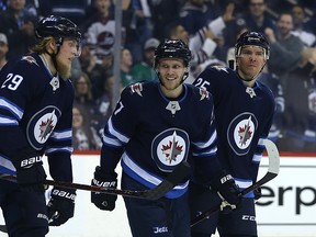 Winnipeg Jets forward Patrik Laine (right) is congratulated on his goal against the Dallas Stars by Nik Ehlers (centre) and Paul Stastny on Sunday. (Kevin King/Winnipeg Sun/Postmedia) Network