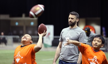 Edmonton Eskimos quarterback Mike Reilly watches students throw and catch during a Jumpstart event at the RBC Convention Centre that is part of CFL Week in Winnipeg on Thurs., March 22, 2018. Over 150 kids from Greenway and Victory schools were able to participate in drills with current CFL stars. Kevin King/Winnipeg Sun/Postmedia Network